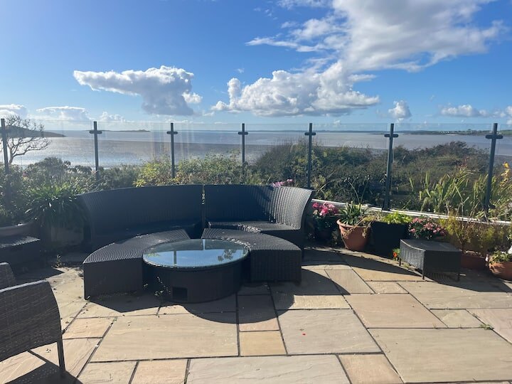 Private terrace seating with views across Fleet Bay