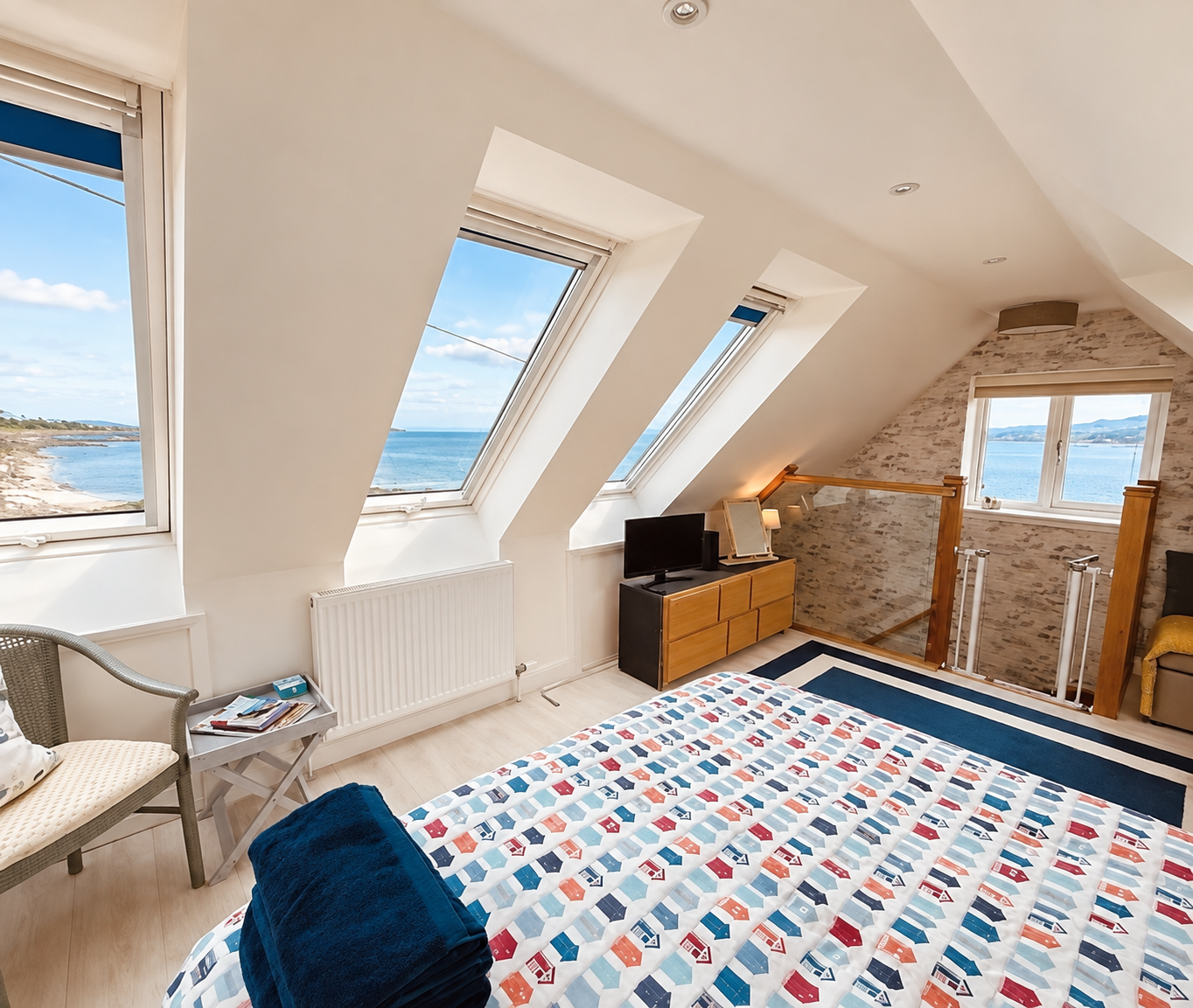 The Boat House bedroom with large Velux windows overlooking the sea