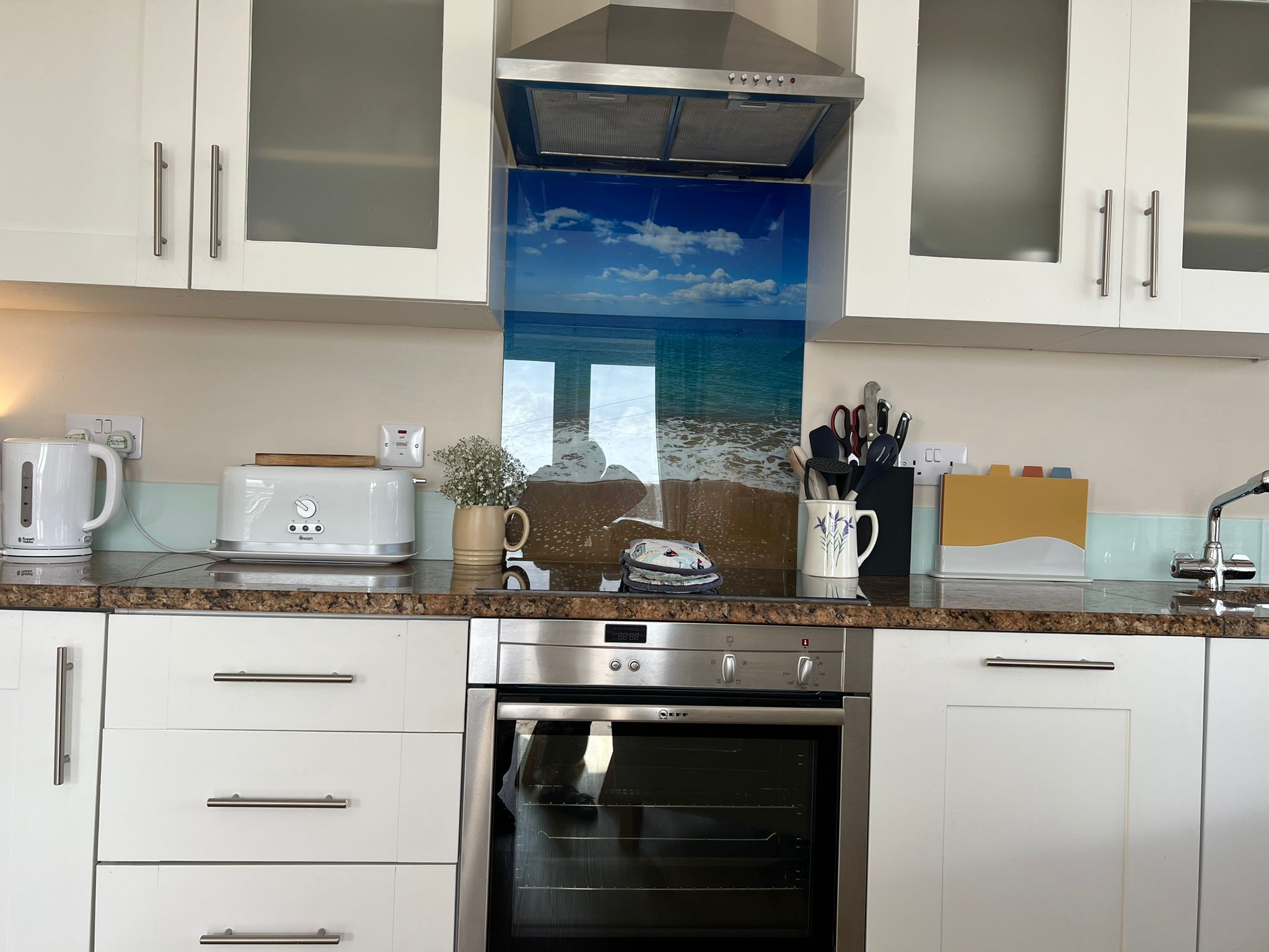 The Boat House kitchen with coastal glass splashback