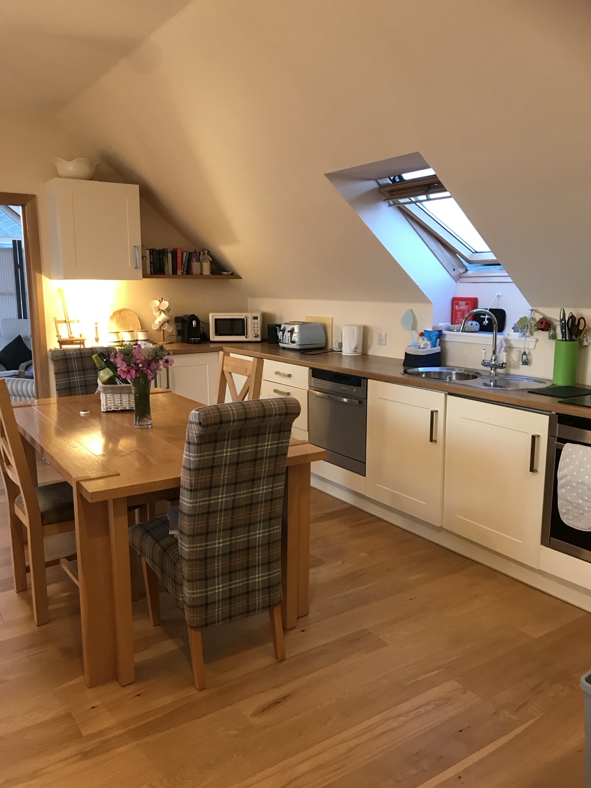 The Sunset Loft's fully equipped kitchen and wooden dining table