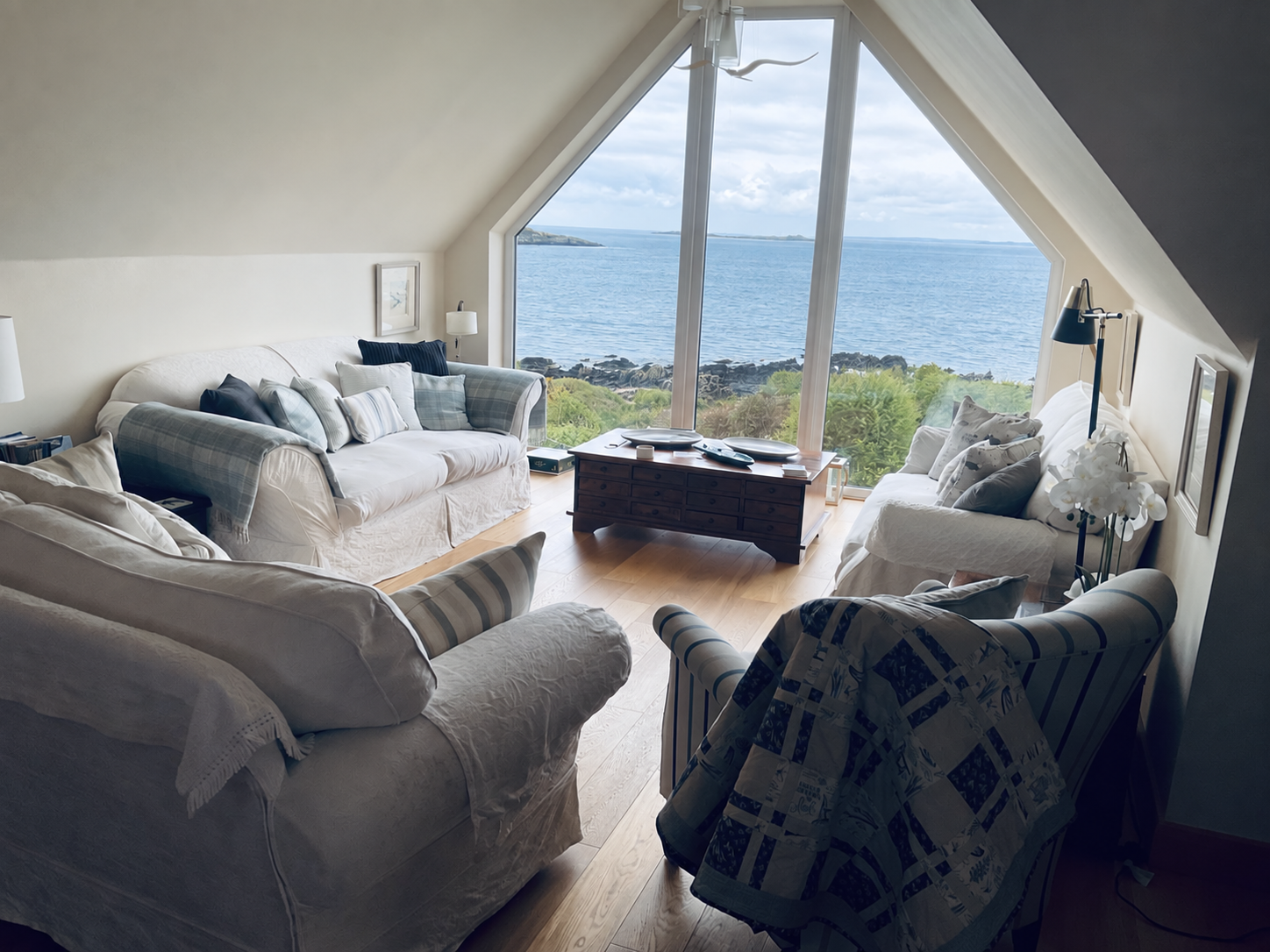 The Sunset Loft main living room with panoramic sea views