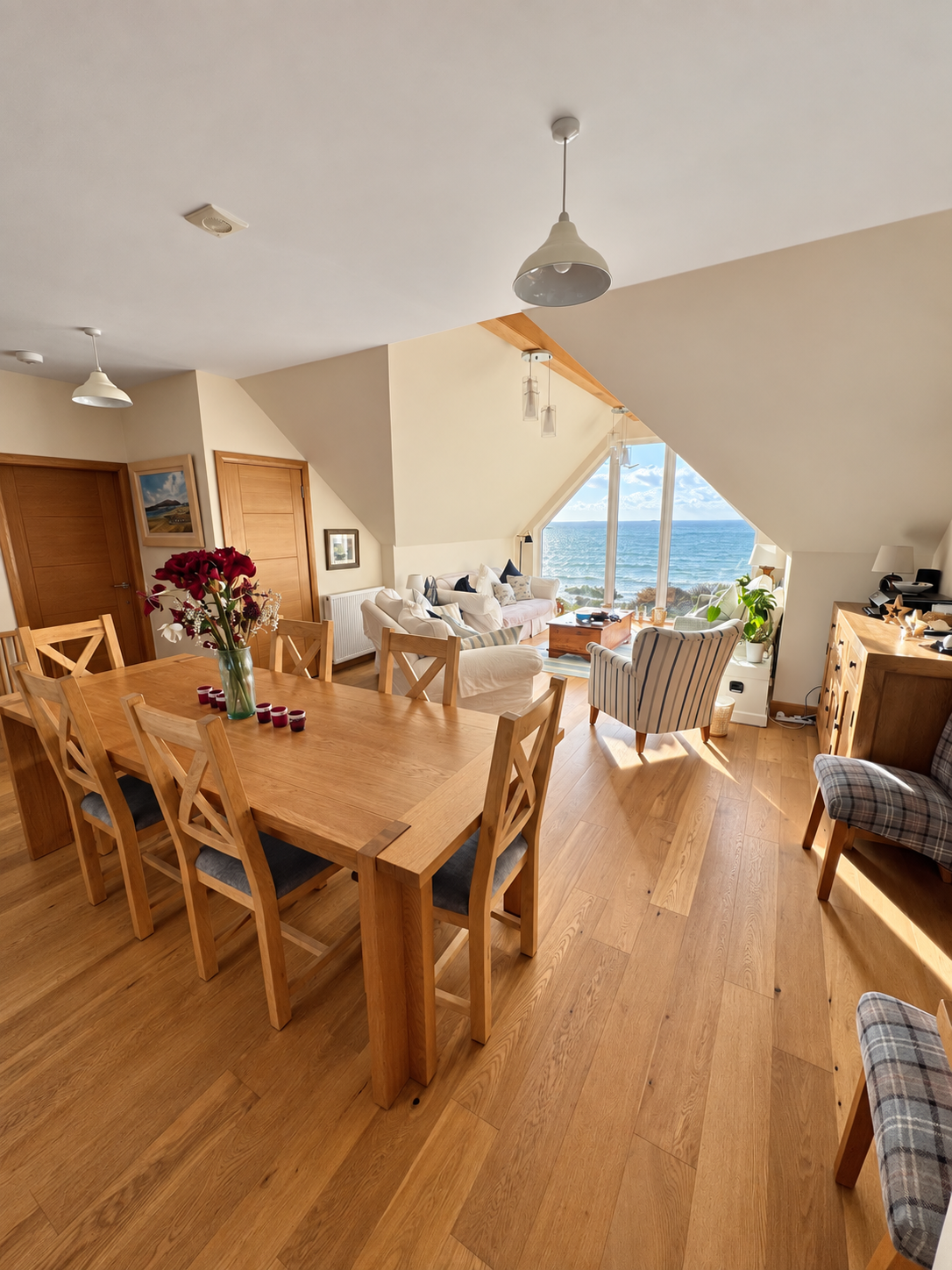 The Sunset Loft open-plan dining and living space facing Fleet Bay